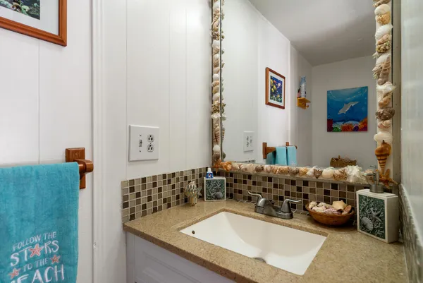 a bathroom with a sink mirror and vanity