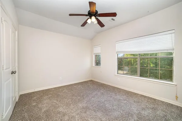 a view of room with window and ceiling fan