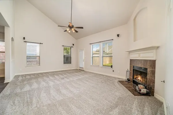 a view of empty room with a fireplace and fan