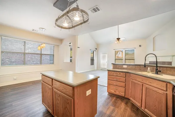 a kitchen with sink cabinets and wooden floor