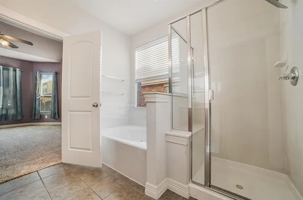 a bathroom with a bathtub and a shower