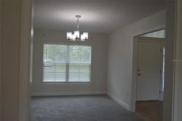 a kitchen with stainless steel appliances granite countertop a refrigerator a stove and a sink with wooden floor