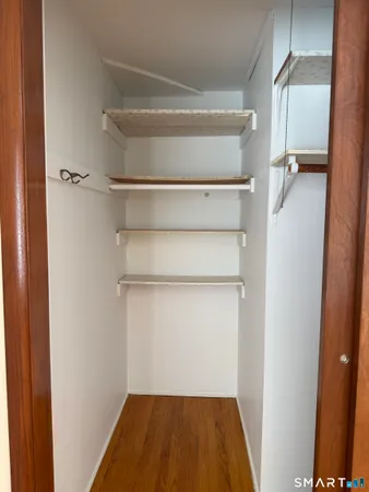 a view of walk in closet with empty racks