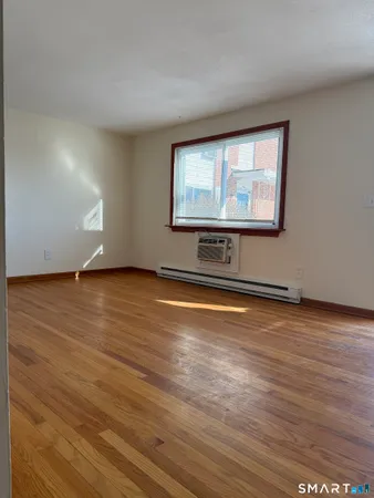 a view of room with wooden floor and window