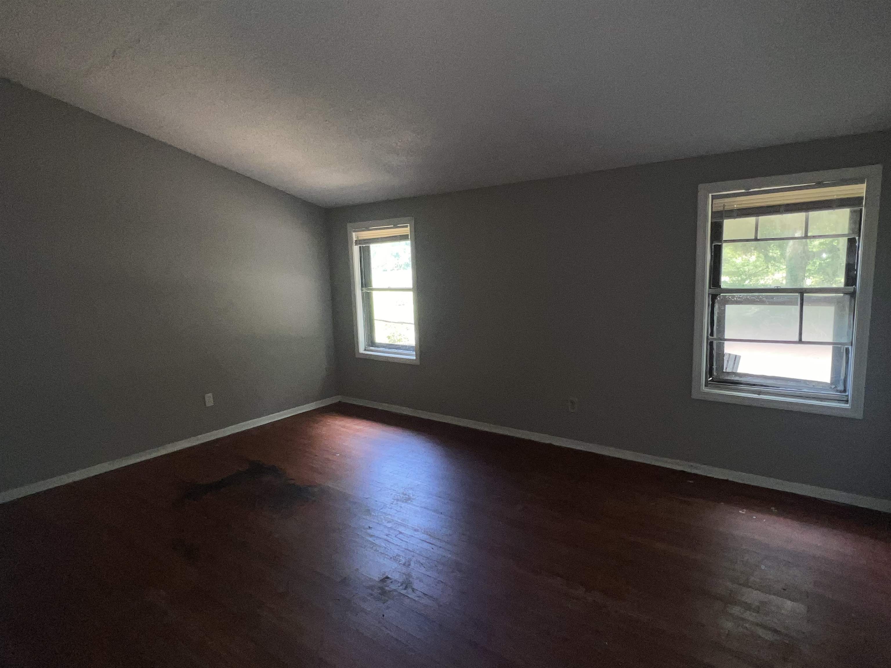 2950 Invergarry Road Memphis, TN 38128 - Photo 8 of 19 Empty room with lofted ceiling, wood-type flooring, and a wealth of natural light
