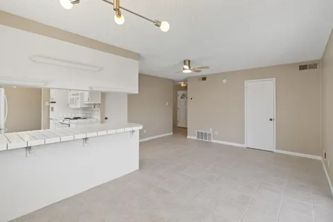 a view of staircase with wooden floor and white walls
