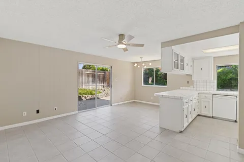 a kitchen with white cabinets and white appliances