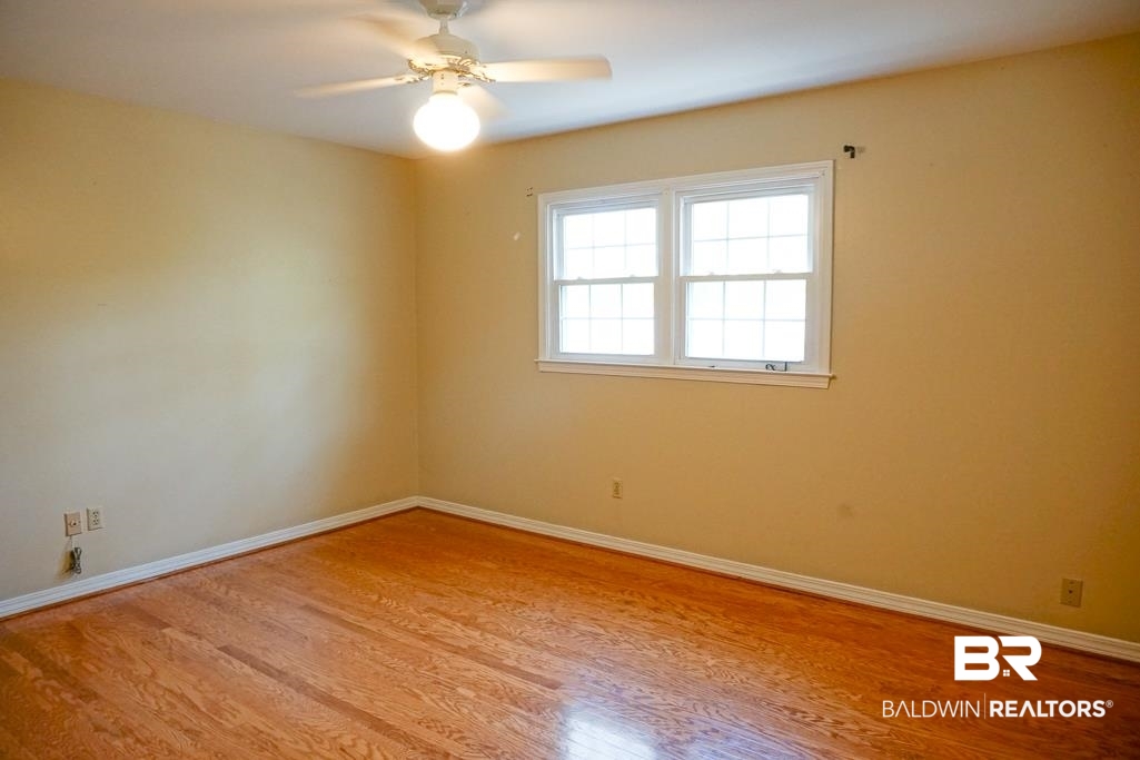 255 Suffolk Road Mobile, AL 36608 - Photo 24 of 29 Empty room featuring light wood finished floors and a ceiling fan