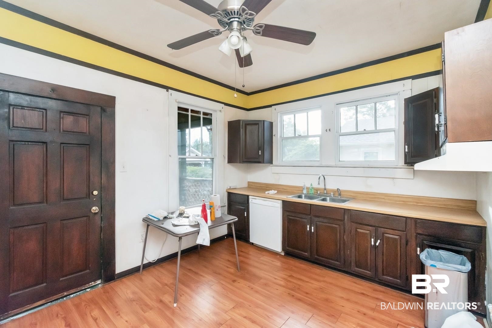 4305 Stein Street Mobile, AL 36608 - Photo 10 of 22 Kitchen featuring sink, crown molding, white dishwasher, dark brown cabinets, and light wood-type flooring