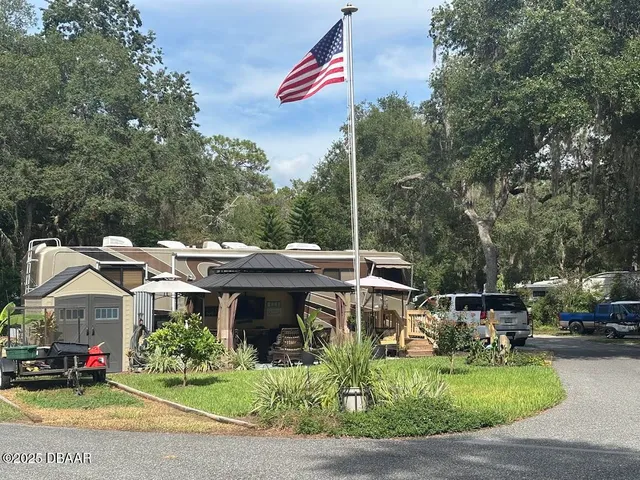 a view of house with outdoor space and sitting area