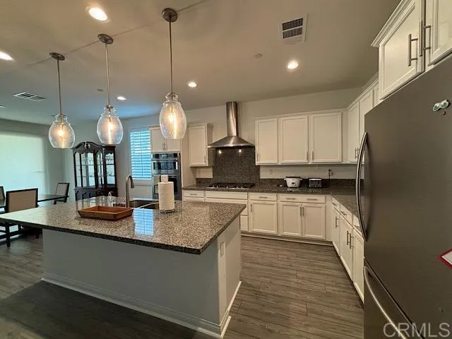 a kitchen with counter space appliances and a view of living room