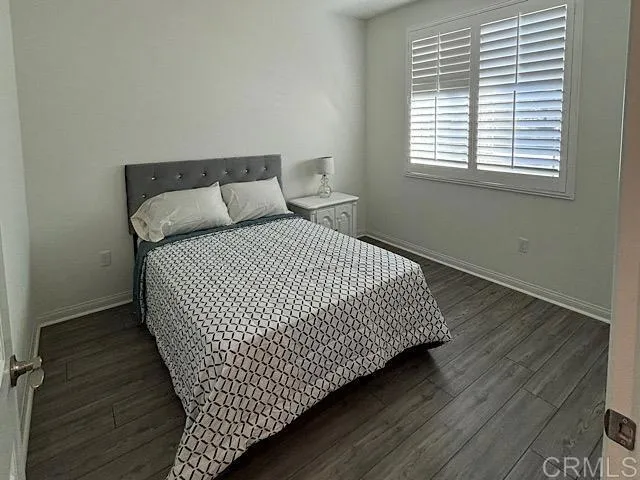 a bed sitting in a bedroom next to a window