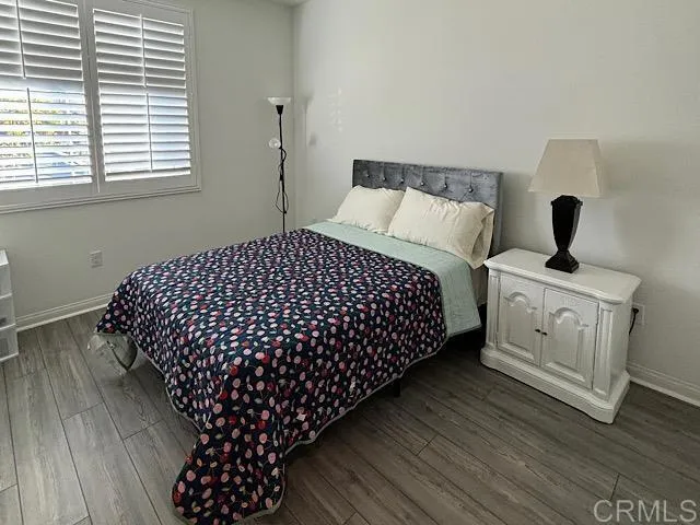 a bedroom with bed and dresser