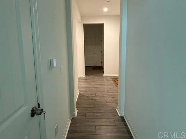 a view of a hallway with wooden floor