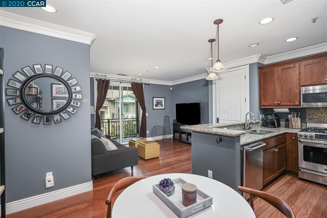 3404 Fostoria Way, Unit 221 Danville, CA 94526 - Photo 1 of 1 a living room with a couch a rug kitchen view and a window