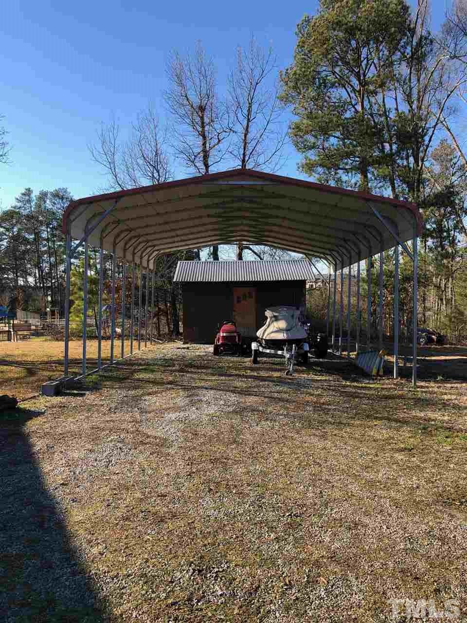 4603 Hopson Road Durham, NC 27703 - Photo 21 of 24 The taller carport could be used for an RV, boat or travel trailer.