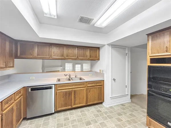 a kitchen with a refrigerator and more cabinets