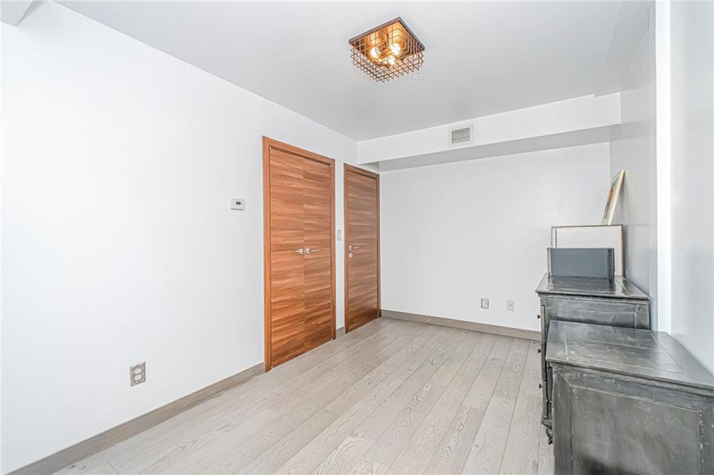 3567 Shore Parkway, Unit H4A Brooklyn, NY 11235 - Photo 16 of 35 an empty room with wooden floor