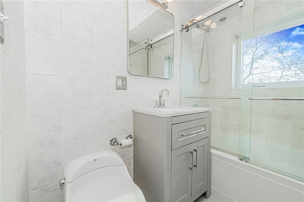 3567 Shore Parkway, Unit H4A Brooklyn, NY 11235 - Photo 17 of 35 a bathroom with a sink a toilet and shower