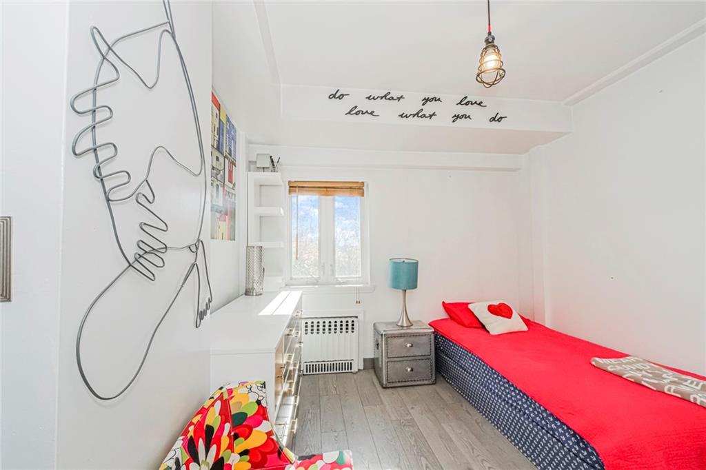 3567 Shore Parkway, Unit H4A Brooklyn, NY 11235 - Photo 18 of 35 a bedroom with a bed and wooden floor