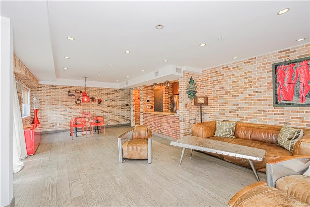 3567 Shore Parkway, Unit H4A Brooklyn, NY 11235 - Photo 2 of 35 a living room with furniture and kitchen view