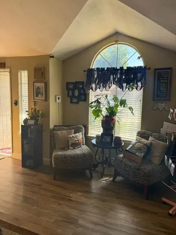 a living room with furniture chandelier and a fireplace