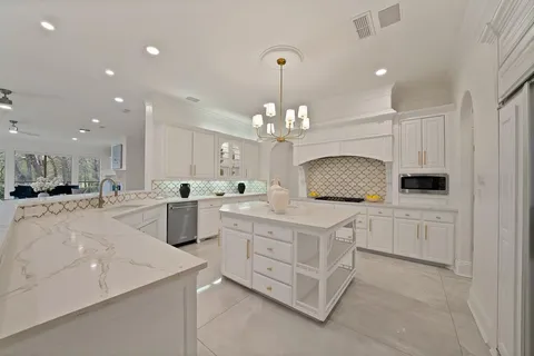 a kitchen with white cabinets and white appliances