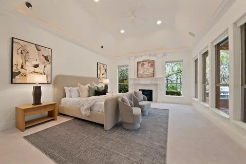 a spacious bedroom with a bed and a fireplace