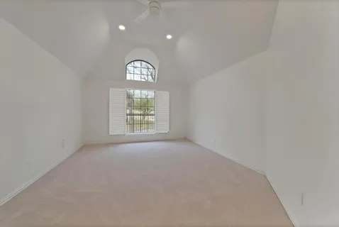 a view of an empty room with a window and balcony