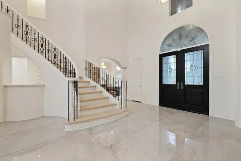 a view of entryway and hall with a front door