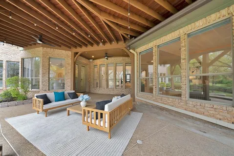 a view of a porch with furniture and garden
