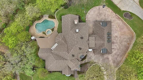 an aerial view of a house with a yard and garden