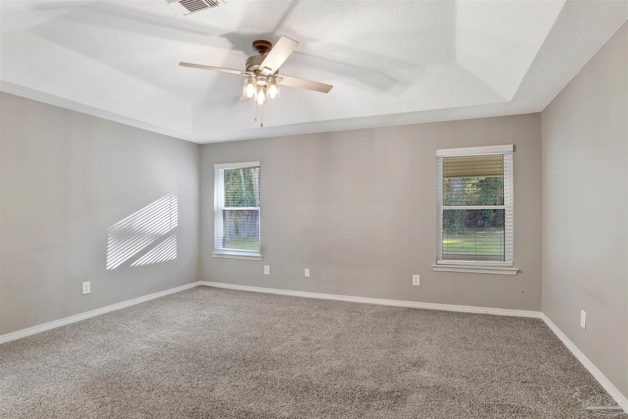 5801 Loring Drive Milton, FL 32583 - Photo 11 of 27 an empty room with windows and fan
