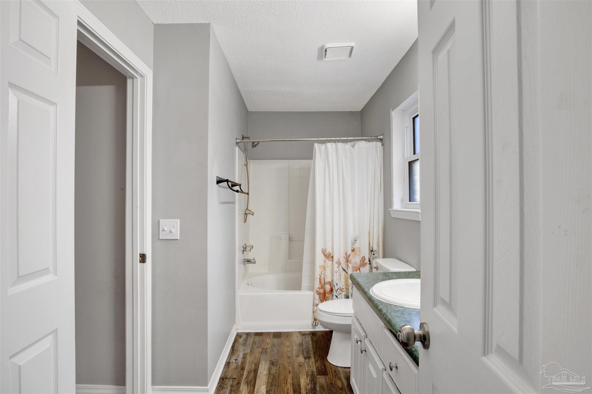 5801 Loring Drive Milton, FL 32583 - Photo 13 of 27 a bathroom with a bathtub a sink and a shower