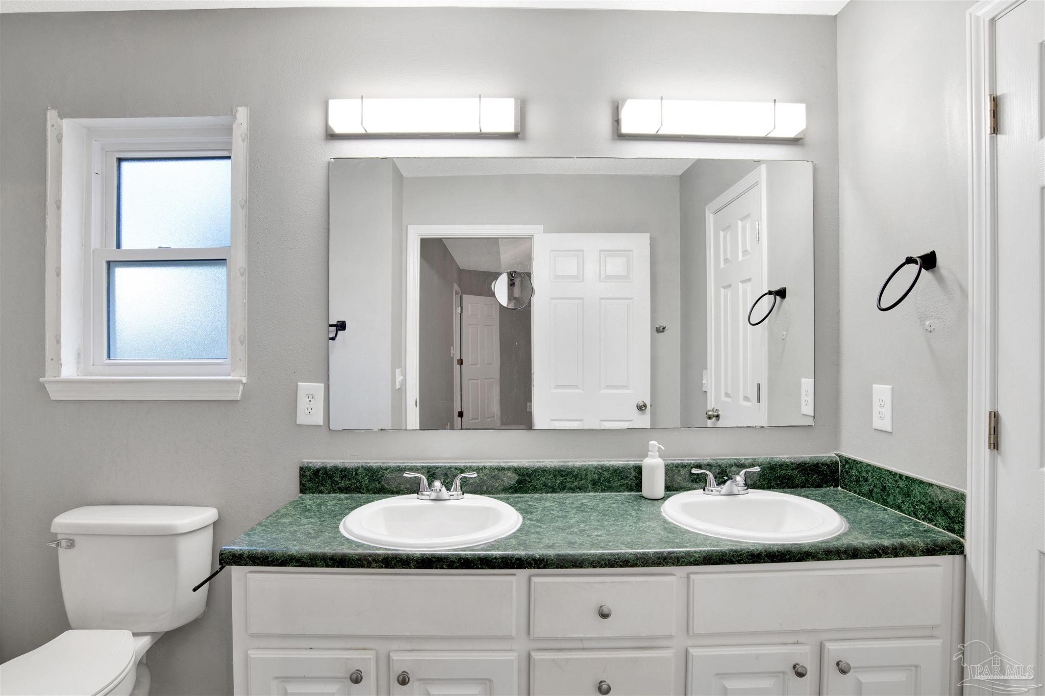 5801 Loring Drive Milton, FL 32583 - Photo 14 of 27 a bathroom with sink and mirror