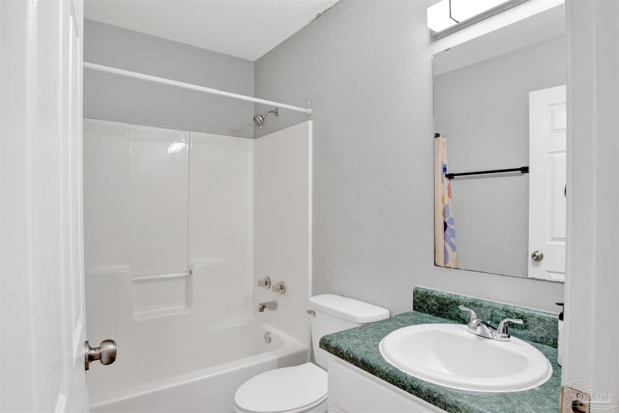 5801 Loring Drive Milton, FL 32583 - Photo 17 of 27 a bathroom with a sink toilet and shower