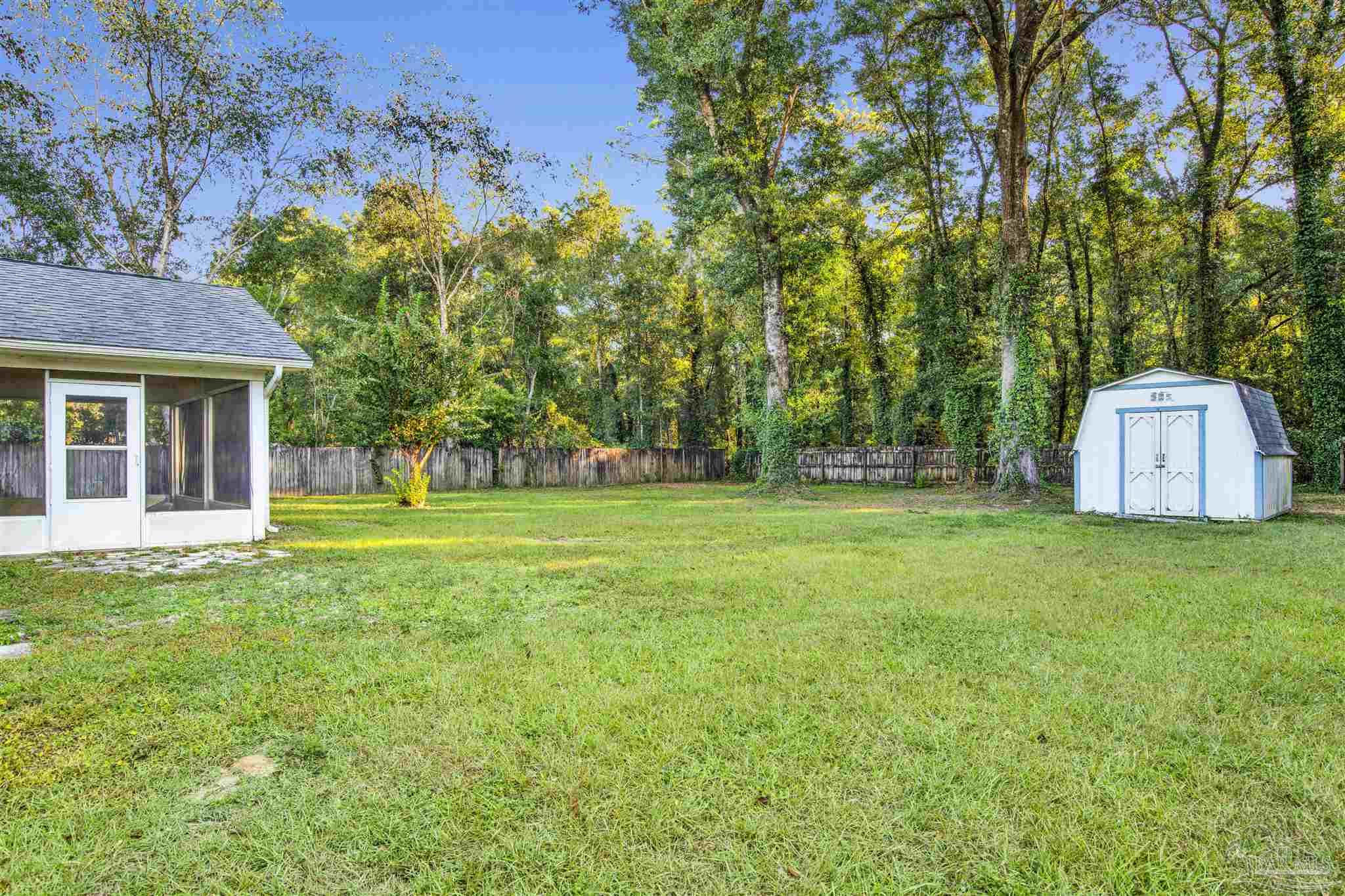 5801 Loring Drive Milton, FL 32583 - Photo 22 of 27 a view of a house with backyard and trees