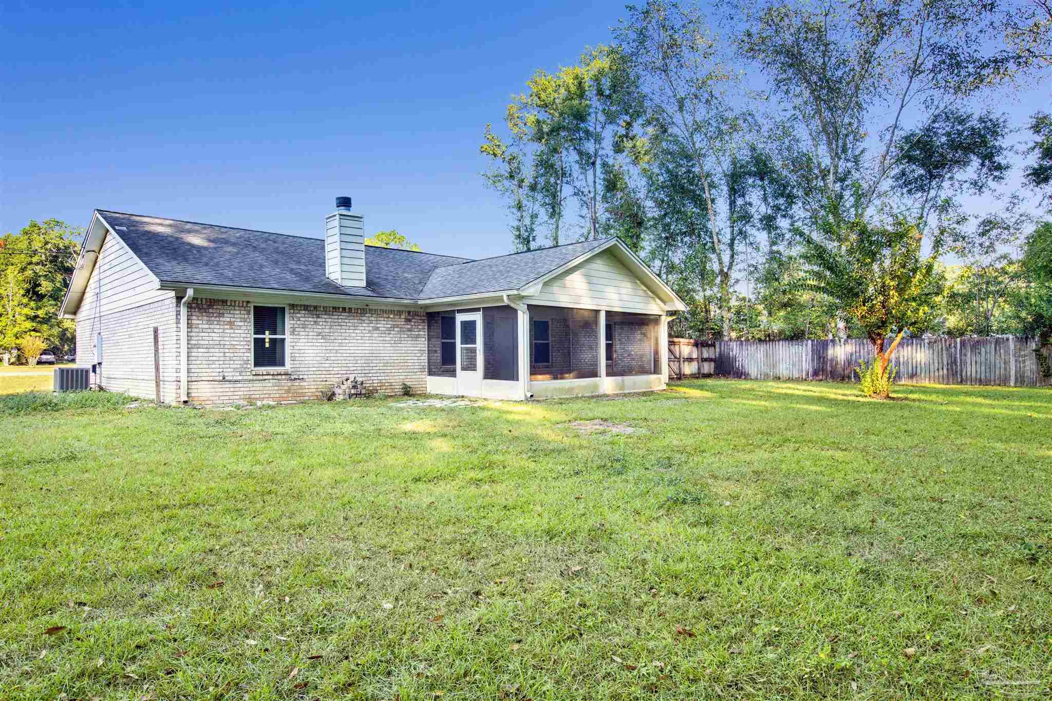 5801 Loring Drive Milton, FL 32583 - Photo 23 of 27 a front view of house with yard and green space
