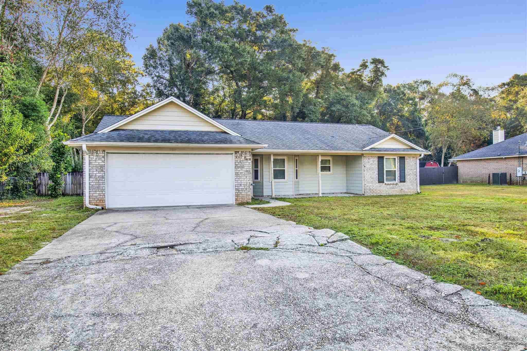 5801 Loring Drive Milton, FL 32583 - Photo 26 of 27 a front view of a house with a yard and garage