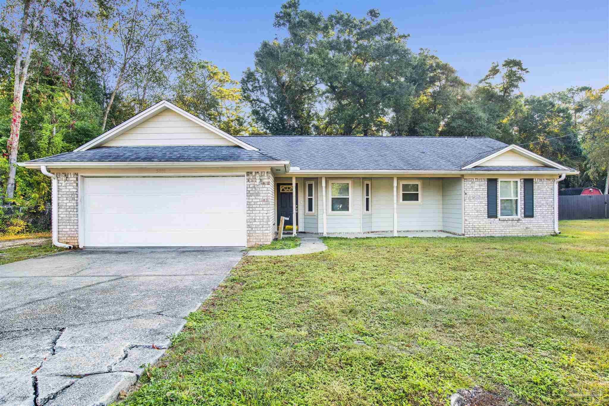 5801 Loring Drive Milton, FL 32583 - Photo 27 of 27 a front view of a house with a garden