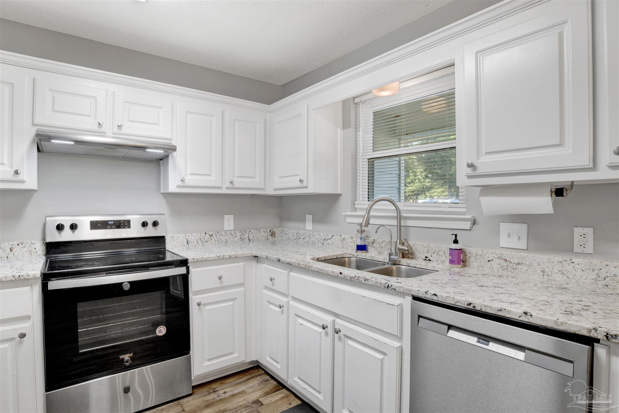 5801 Loring Drive Milton, FL 32583 - Photo 10 of 27 a kitchen with stainless steel appliances granite countertop a sink stove and cabinets
