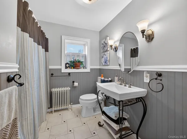a bathroom with a sink mirror and toilet