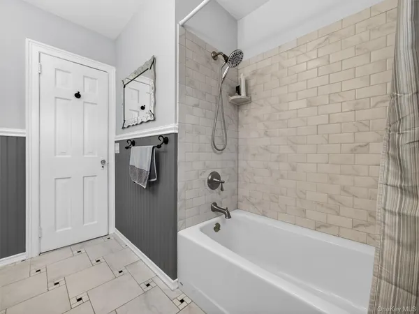 a bathroom with a bathtub and shower