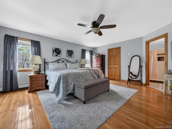 a bedroom with a bed couch and a window