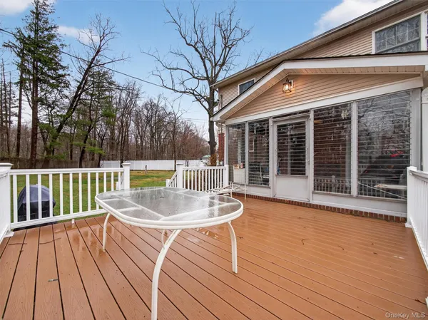 a view of a deck with a white fence