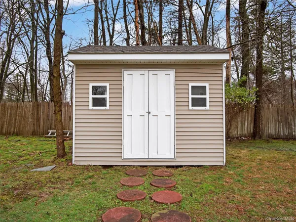 a view of a house with a big yard and a large tree