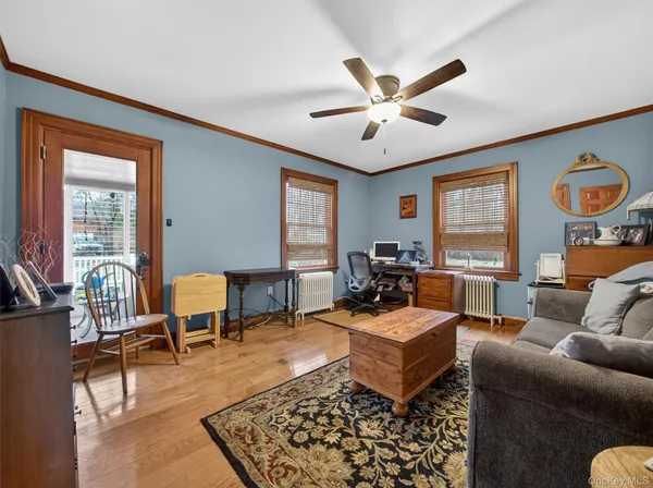 a living room with furniture two window and a rug