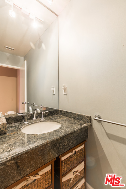3012 Arrowhead Drive Los Angeles, CA 90068 - Photo 17 of 53 a bathroom with a granite countertop sink and a mirror