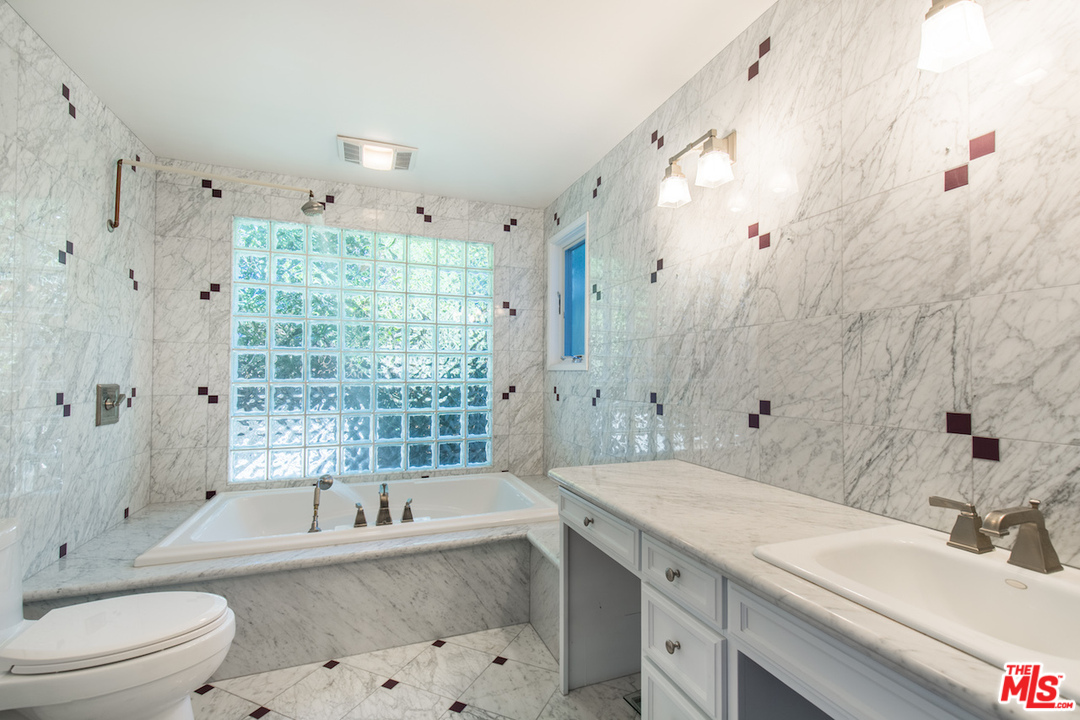 3012 Arrowhead Drive Los Angeles, CA 90068 - Photo 24 of 53 a bathroom with a granite countertop bathtub shower sink vanity mirror and toilet