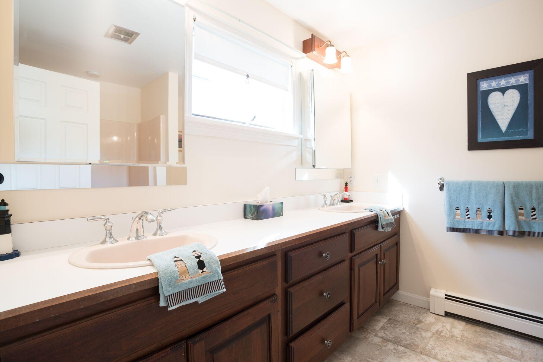 2055 Bridge Road Eastham, MA 02642 - Photo 12 of 22 a bathroom with a sink and a mirror